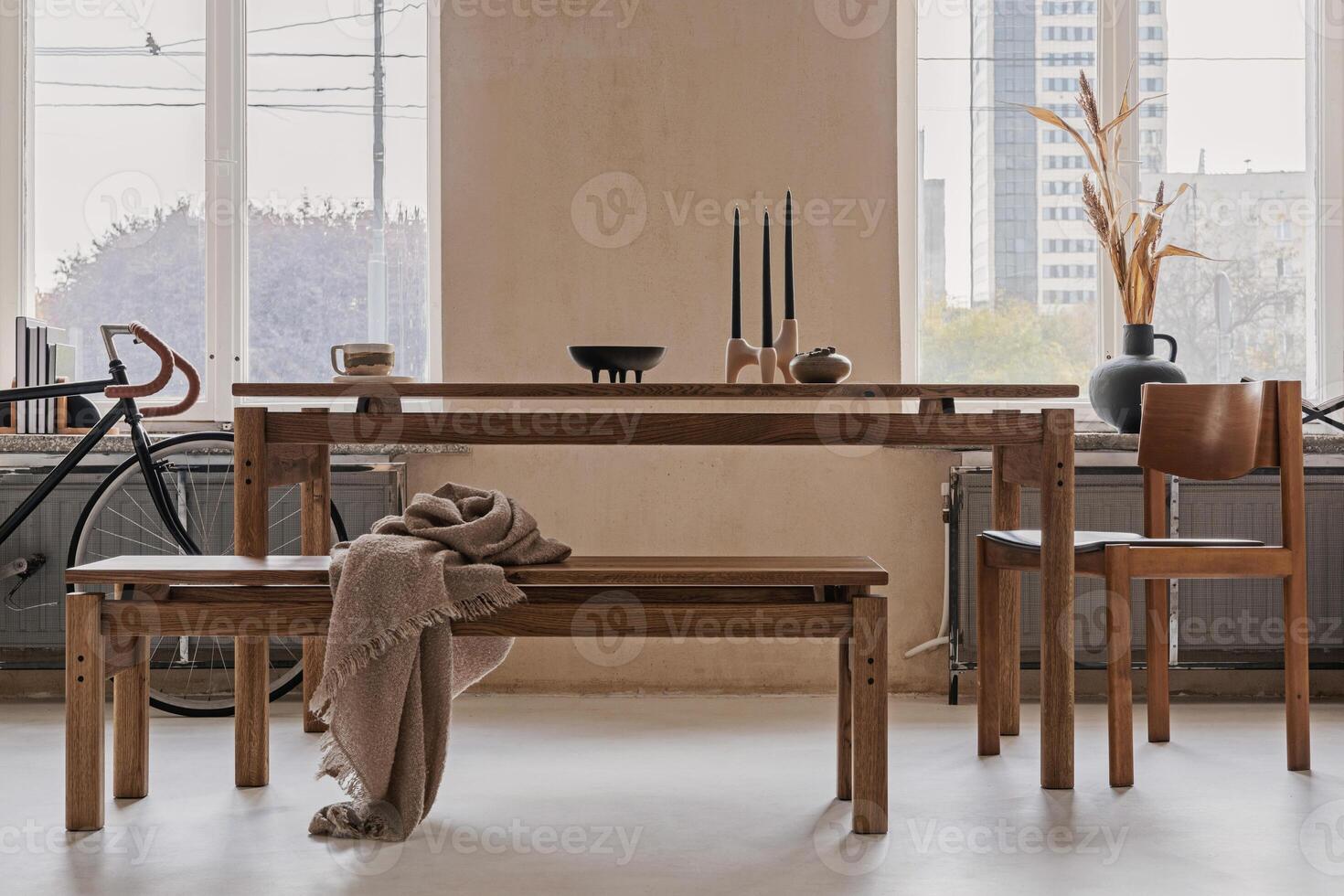 Stylish interior design of spacious dining room with wooden dining table, armchairs and beautiful personal accessories. Modern home decor. Structure wall. Rustic minimalitic inspiration. Template. photo