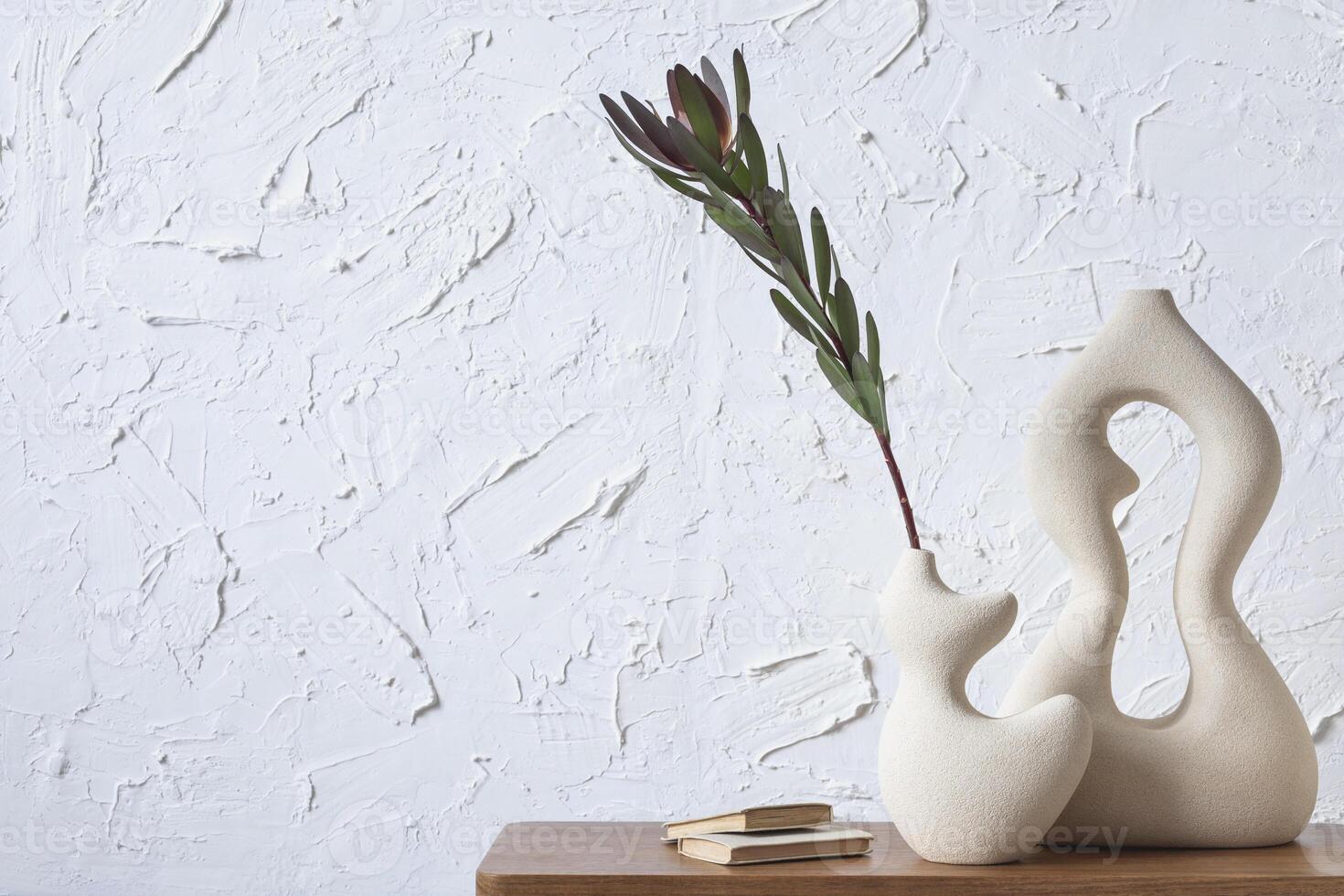 Creative minimalistic composition of home interior with handmade clay vases, sidetable and elegant personal accessories. Copy space. Wall paper. Template. photo