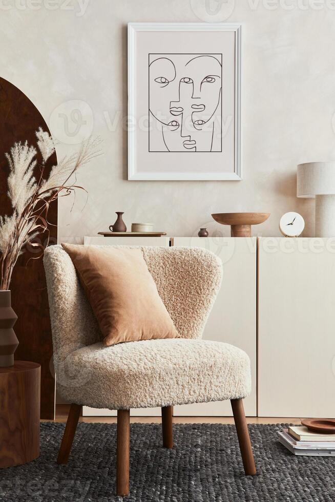 Composition of creative living room interior design with mock up poster frame, fluffy armchair, folding screen, coffee table, commode and personal accessories. Modern style. photo
