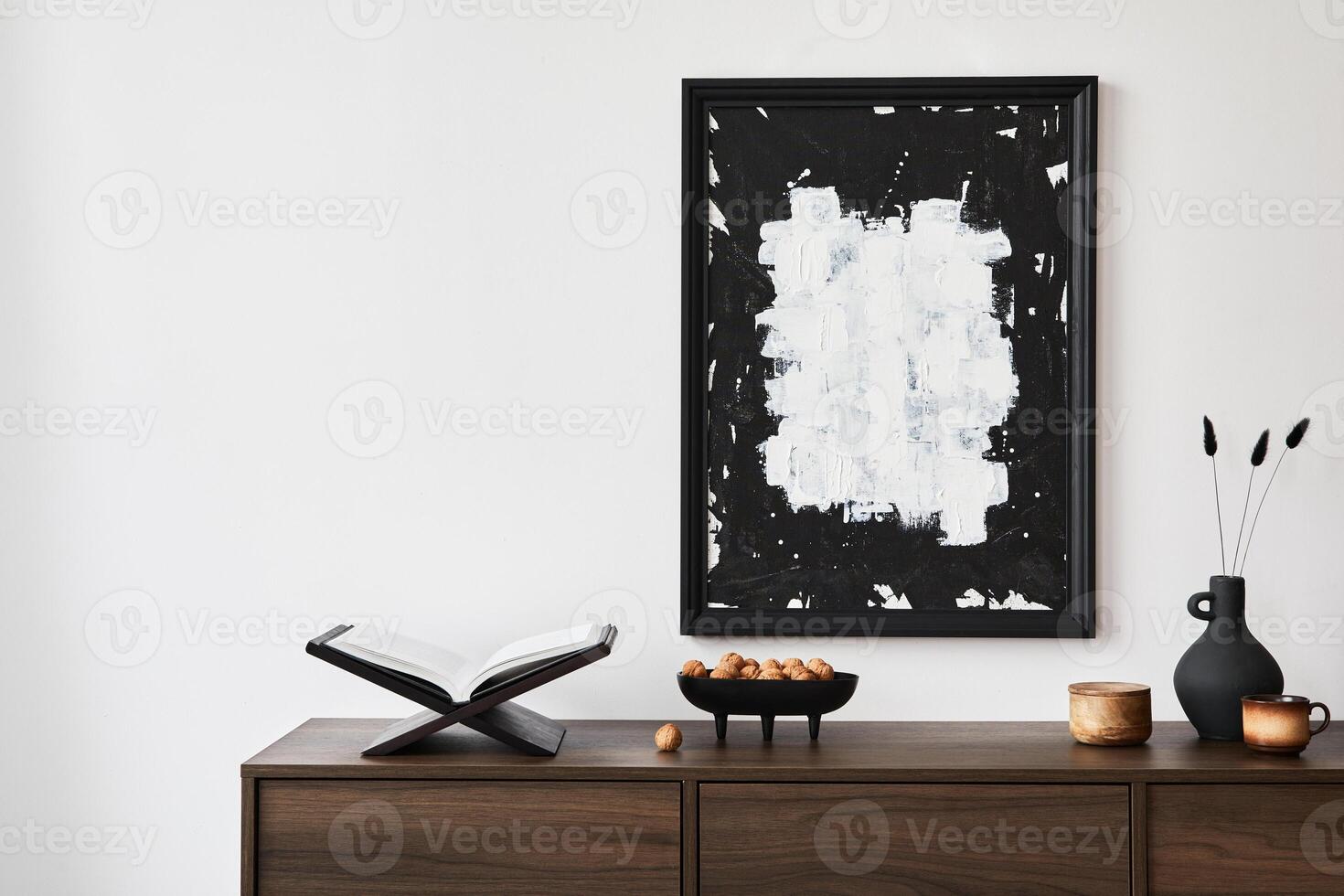 Creative composition of modern living room interior design with mock up poster frame, brown commode and personal accessories. White wall. Copy space. photo