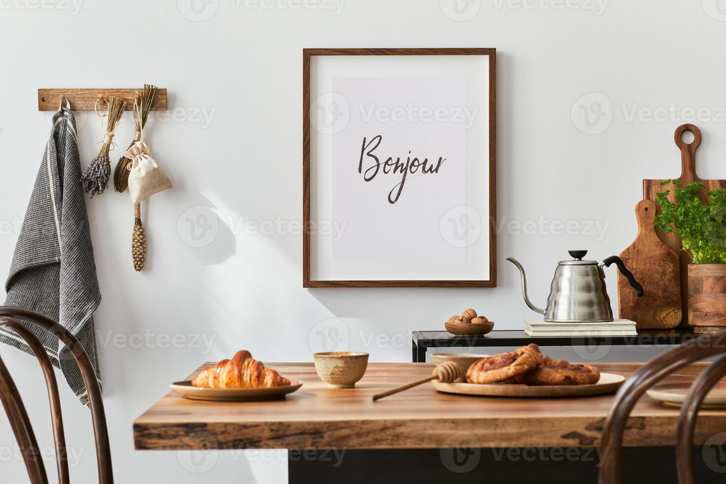 Stylish composition of cozy dining room intrerior with mock up poster frame, wooden family dining table, plants and vintage personal accessories. . Autumn vibes. photo