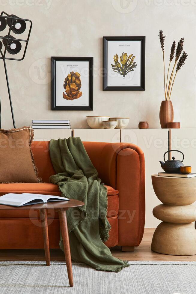 Stylish interior of modern living room with two mock up poster frame, retro design sofa, black lamp and creative personal accessories. Hipster space. Template. photo