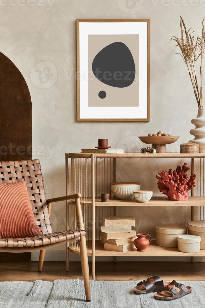Creative composition of living room interior design with console, armchair, mock up poster frame, vase and elegant personal accessories. Copy space. photo
