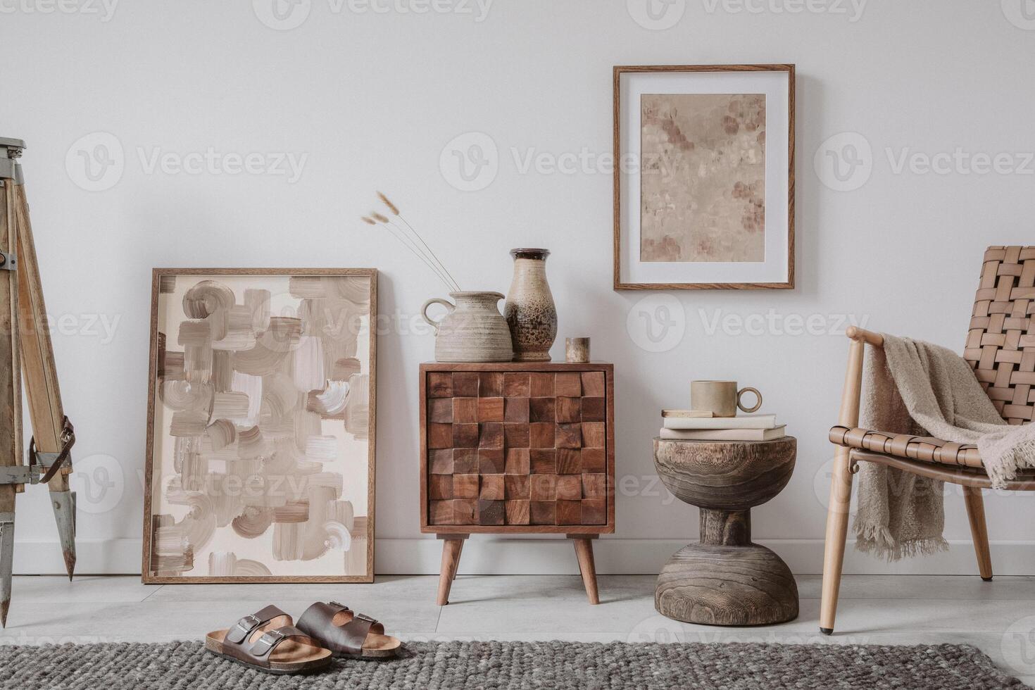 Elegant comosition of masculine room decor with small wooden cupboard, two mockup paintings and vintage accessories. Home staging. Template. Copy space. photo