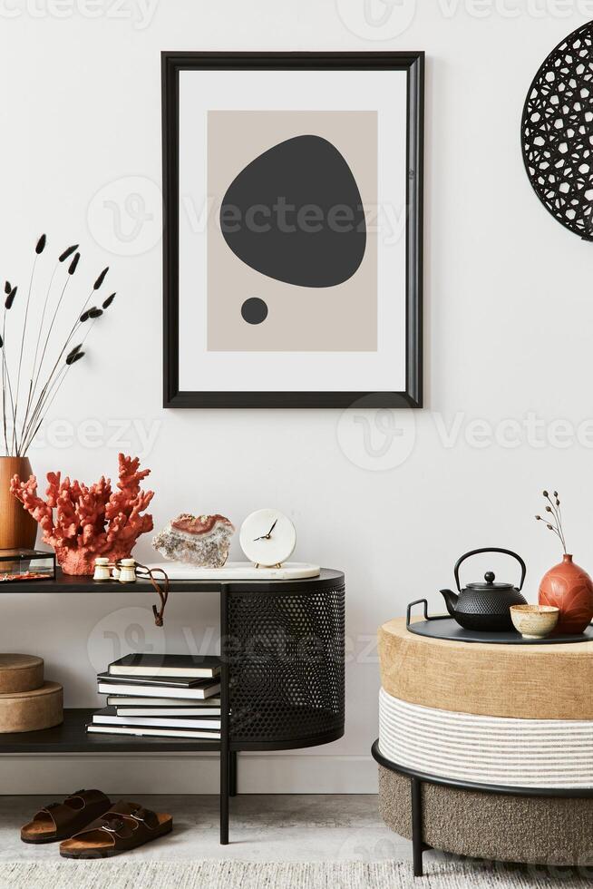 Stylish living room interior composition with mock up poster frame, pouf, console and elegant personal accessories. Template. photo