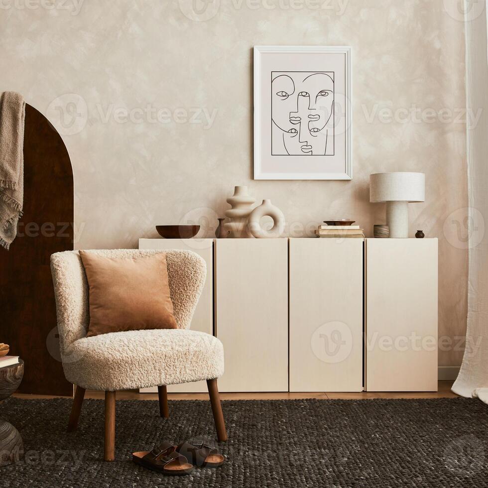 Stylish composition of cozy living room interior design with mock up poster frame, fluffy armchair, folding screen, coffee table, commode and personal accessories. Modern style - Template photo