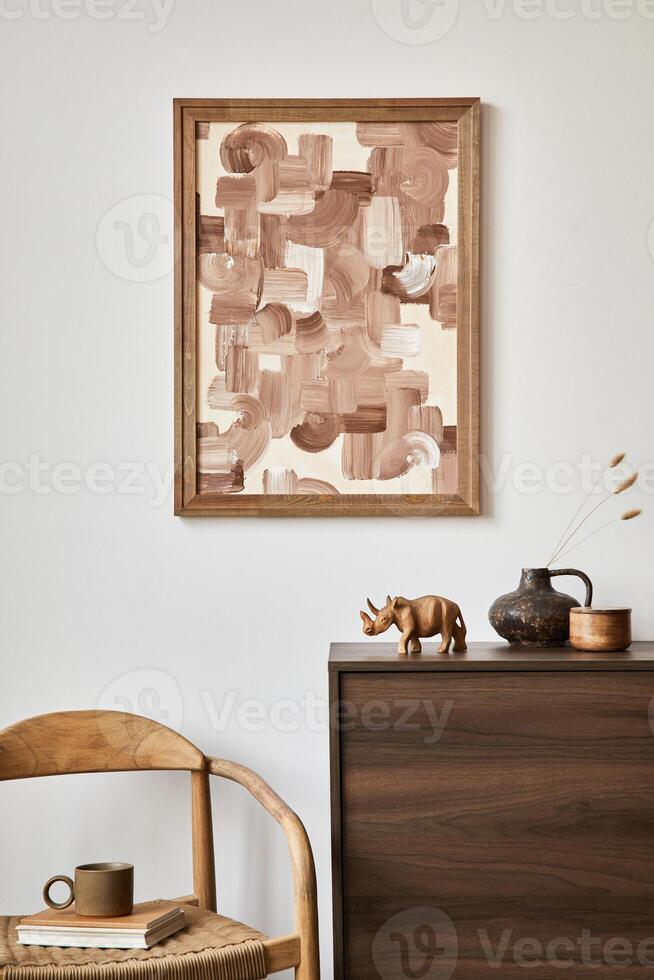 Minimalistic composition of creative living room interior with mock up poster frame, armchair and stylish small personal accessories on wooden commode. Copy space. Real photo. photo