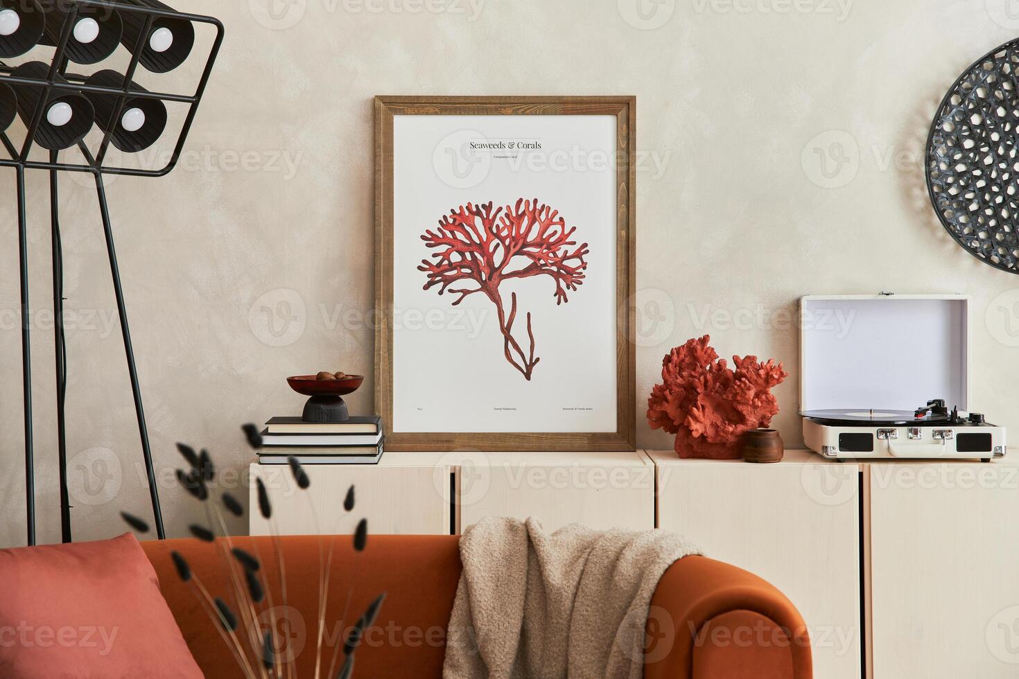 Stylish interior of modern living room with retro design sofa, mock up poster frame, vintage record-player and creative personal accessories. Hipster space. Template. photo