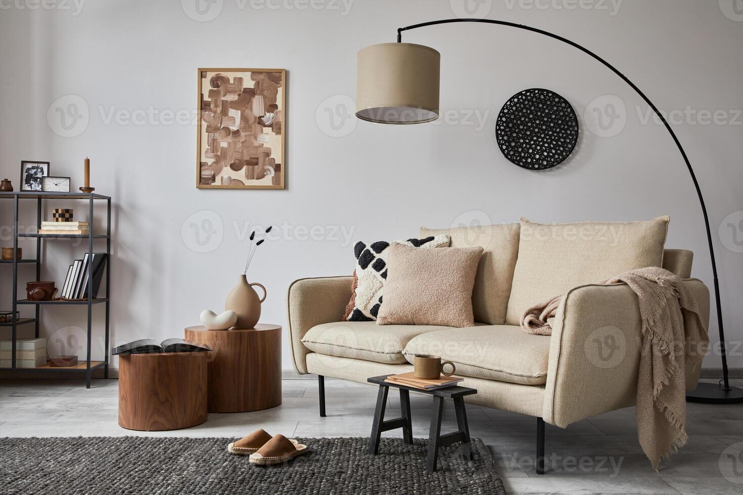 Stylish composition of elegant living room interior design with mock up poster frame, metal and wooden shelf, sofa, wooden side tables and personal accessories. White wall. Copy space. Template. photo