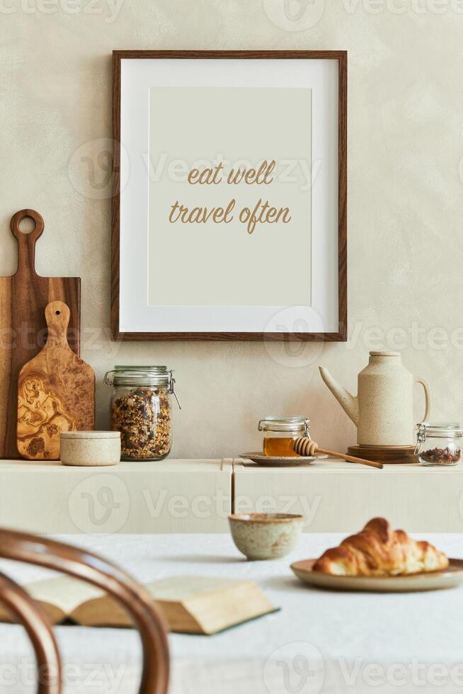 Creative and modern dining room interior design with mock up poster frames, beige sideboard, family dining table and retro inspired personal accessories. Copy space Autumn vibes. photo