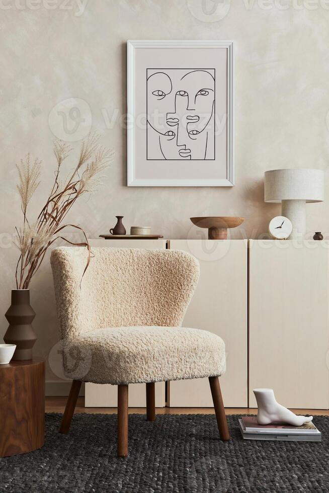 Creative composition of cozy living room interior design with mock up poster frame, fluffy armchair, commode and personal accessories. Modern style. photo