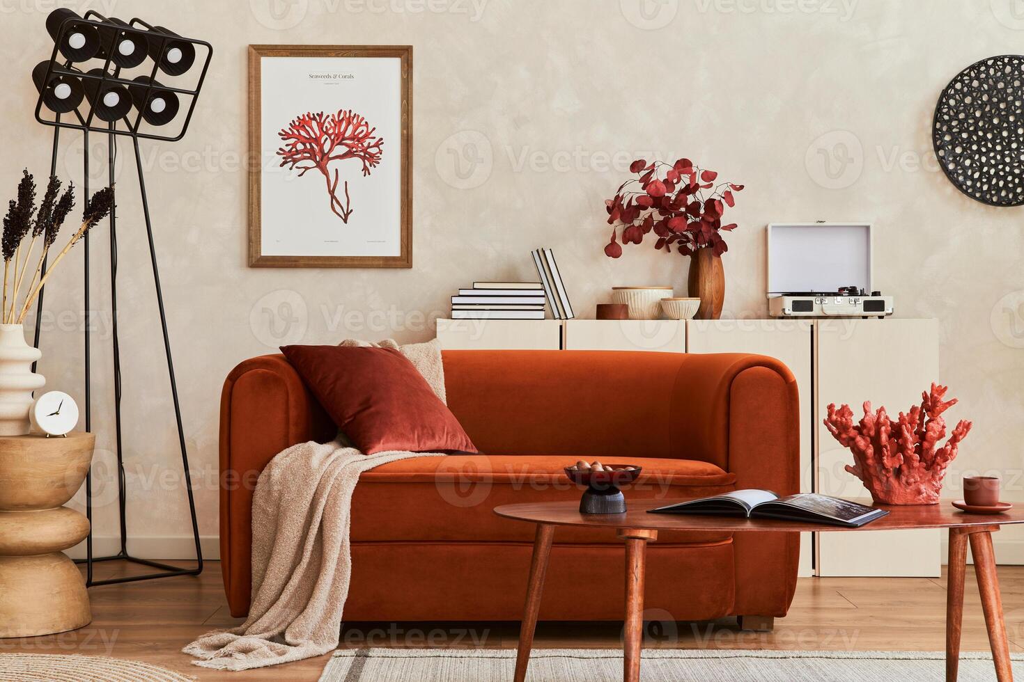 Creative interior composition of living room with mock up poster frame, designed couch, coffee table, plants and personal accessoriers photo