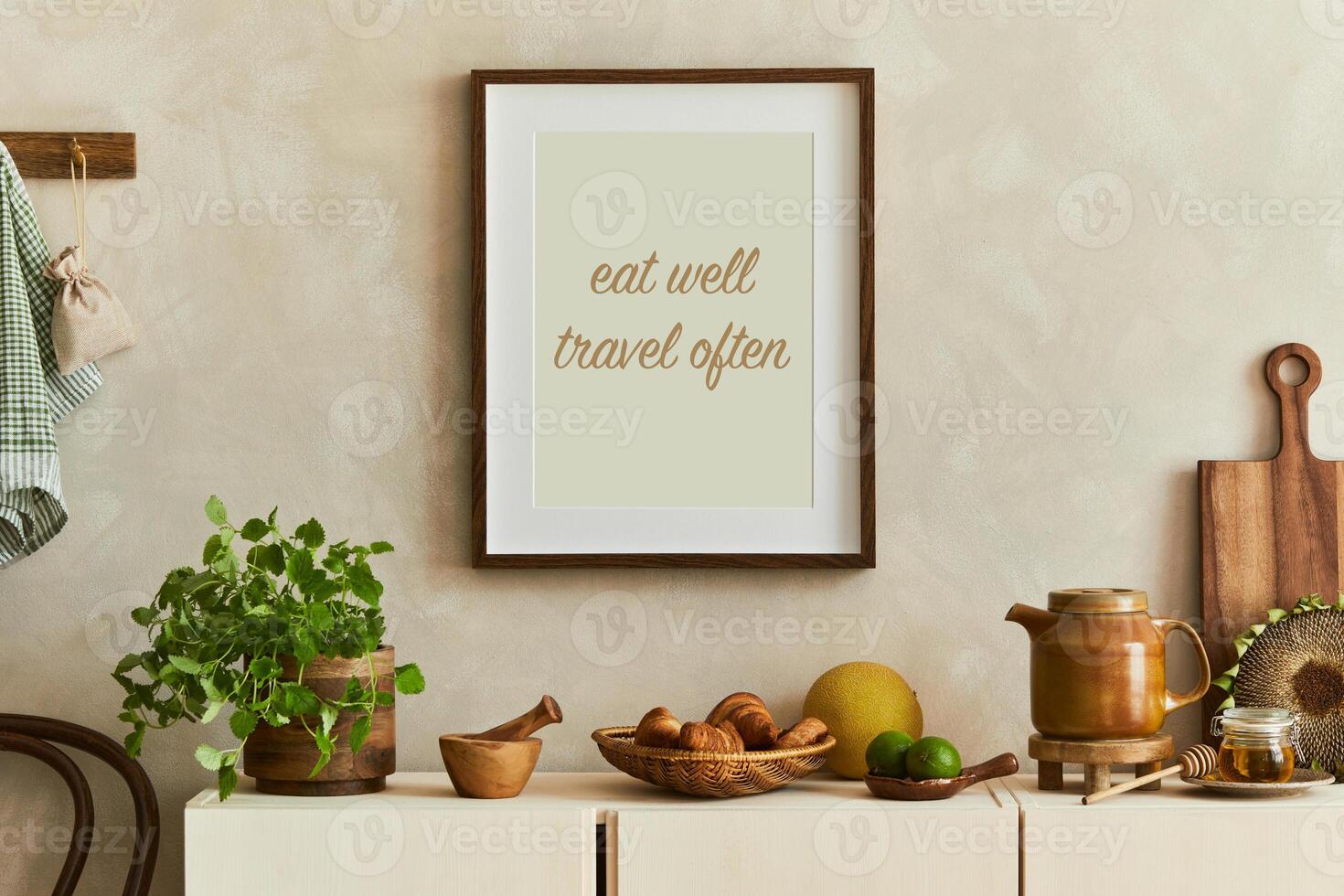 Stylish composition of modern kitchen interior design with mock up poster frames, beige sideboard and retro accessories. Template. Autumn vibes photo