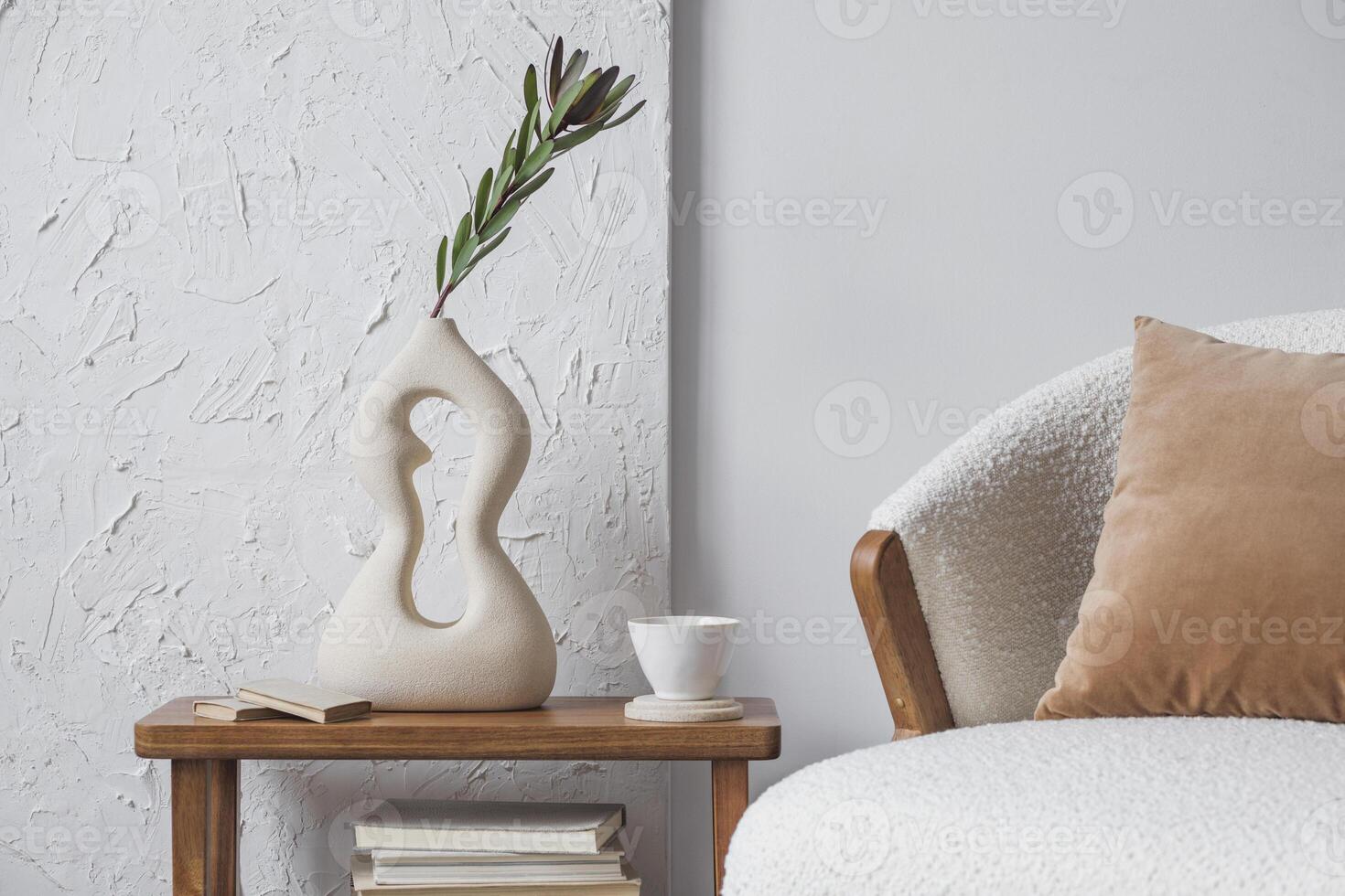 Elegant living room interior design with handmade vases, side table, fluffy armchair and personal accessories. Structure painting on the wall. Copy space. Wallpaper. Template. photo
