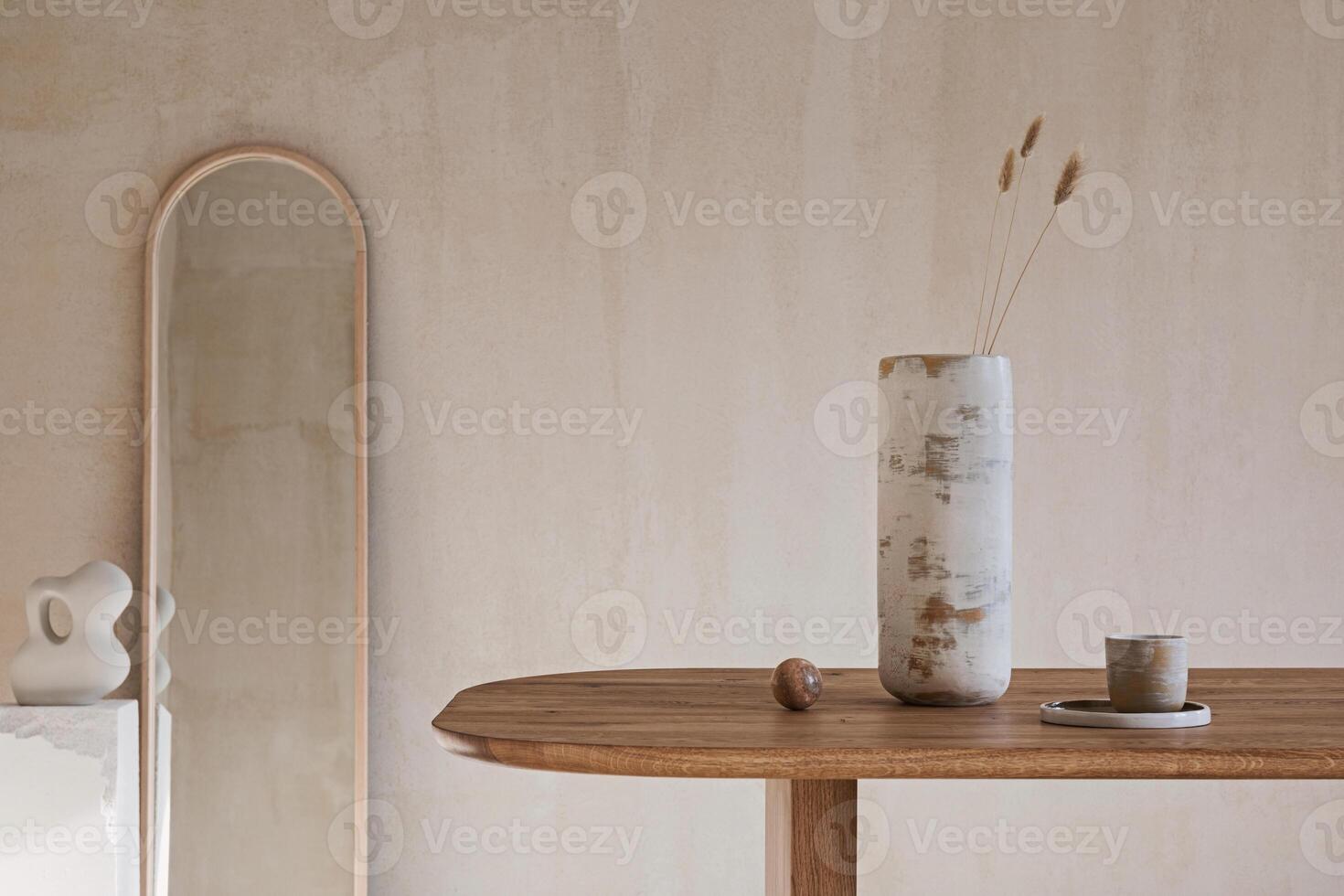 Elegant interior composition with wooden dining table and stylish vase and dining accessories. Modern home decor. Structure wall. Rustic minimalitic inspiration Template photo
