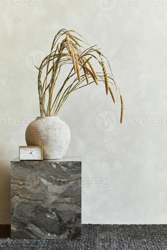 Elegant interior composition with marble cube coffee table and stylish personal accessories and vase. Copy space. photo