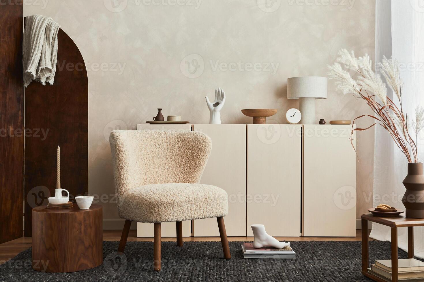 Creative composition of cozy living room interior design with poster frame, fluffy armchair, folding screen, coffee table, commode and personal accessories. Modern style. Template. photo