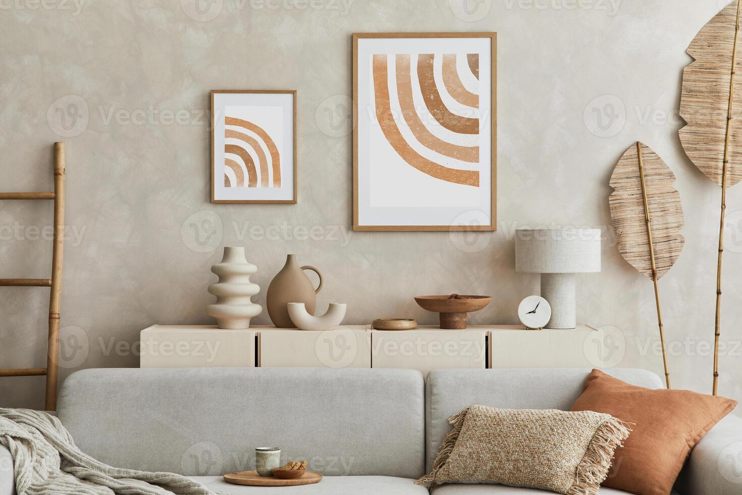 Stylish living room composiiton with mock up poster frame, grey sofa, wooden furnitutre and personal accessories. Pastel neutral colours. Template. photo