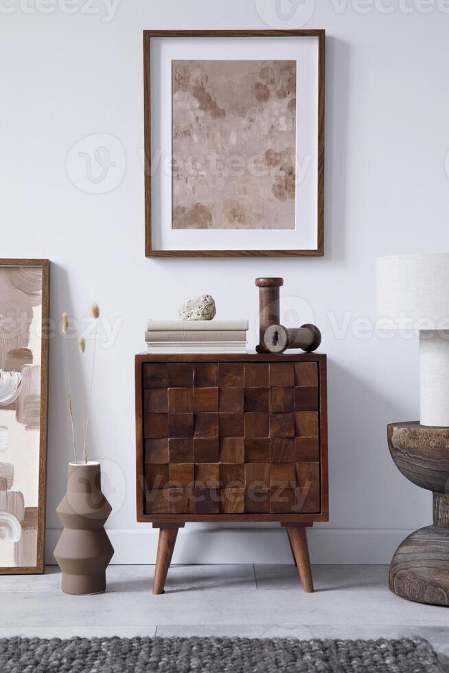 Creative living room interior design with wooden commode, mock up frame and vintage accessories in modern home decor. Home staging. Template. Copy space. photo