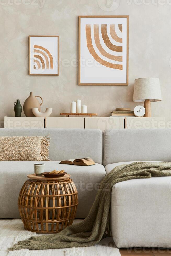 Creative composition of stylish living room interior with mock up poster frame, sofa, commode clay vases and personal accessories. Pastel neutral colours. Template. photo