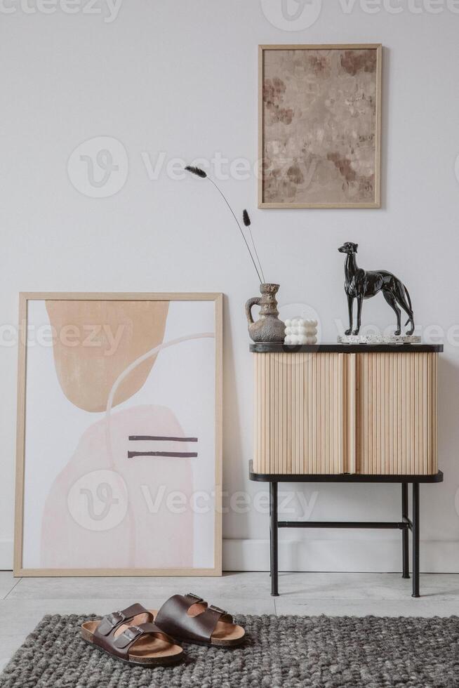 Creative living room interior design. Abstract painting on the wall and mock up poster frame. Stylish accessories on the wooden cupboard. Template. Copy space. photo