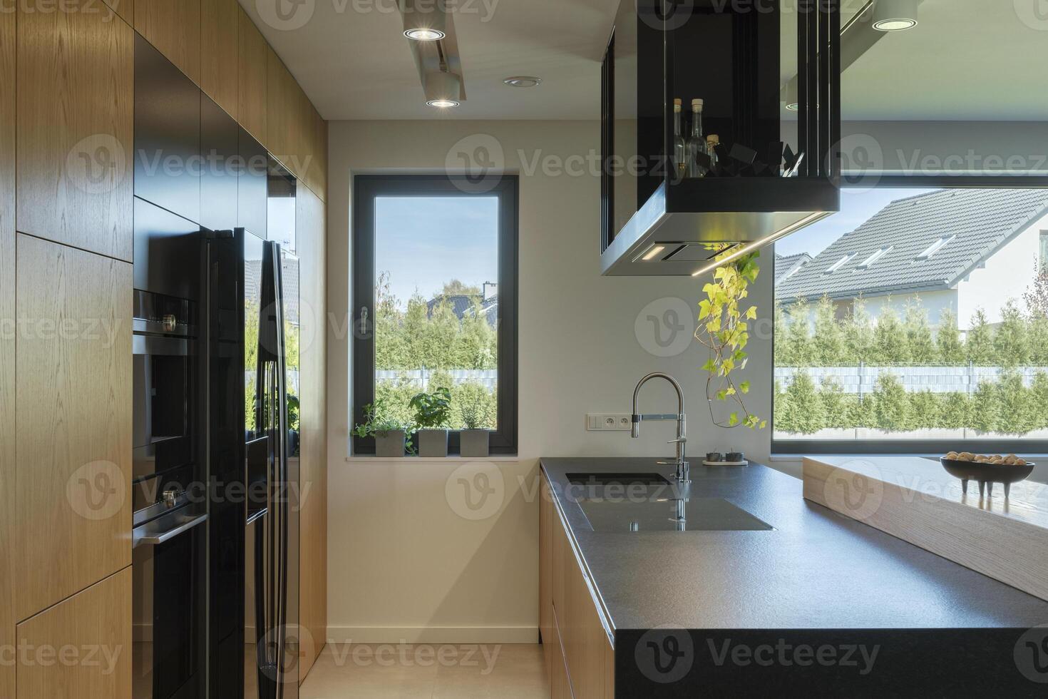 Minimalistic modern wooden panel kitchen interior with ergonomic biuld-in kitchen and kitchen island. Geometric forms and shapes. Details. Template. photo