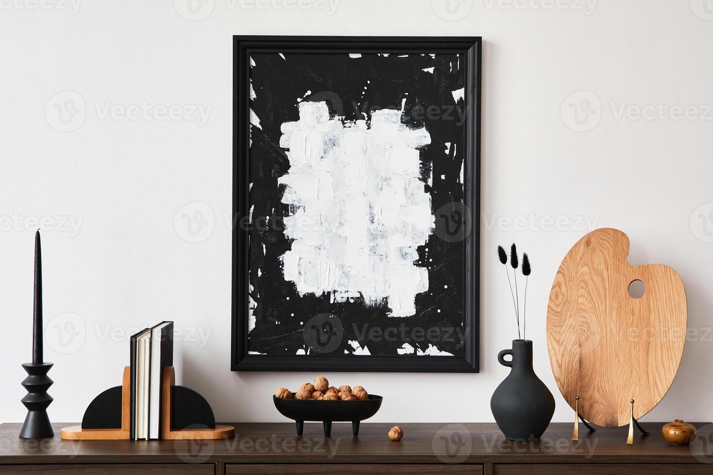 Creative composition of modern living room interior design with poster frame, brown commode, books and personal accessories. White wall. Copy space. Template. photo