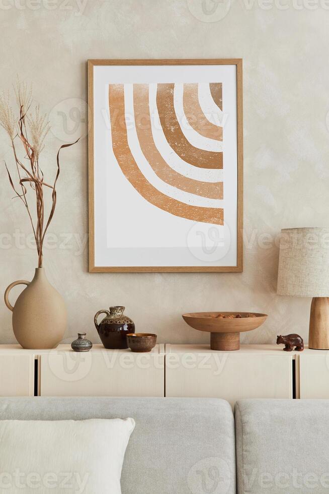 Creative composition of stylish living room with mock up poster frame, sofa, commode, clay vases and stylish personal accessories. Pastel neutral colours. Template. photo
