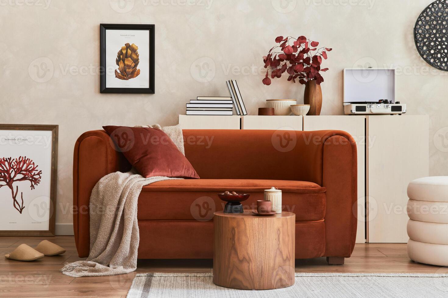 Creative interior composition of living room with mock up poster frame, designed couch, coffee table, vintage record-player, pouf and personal accessoriers. Template. photo