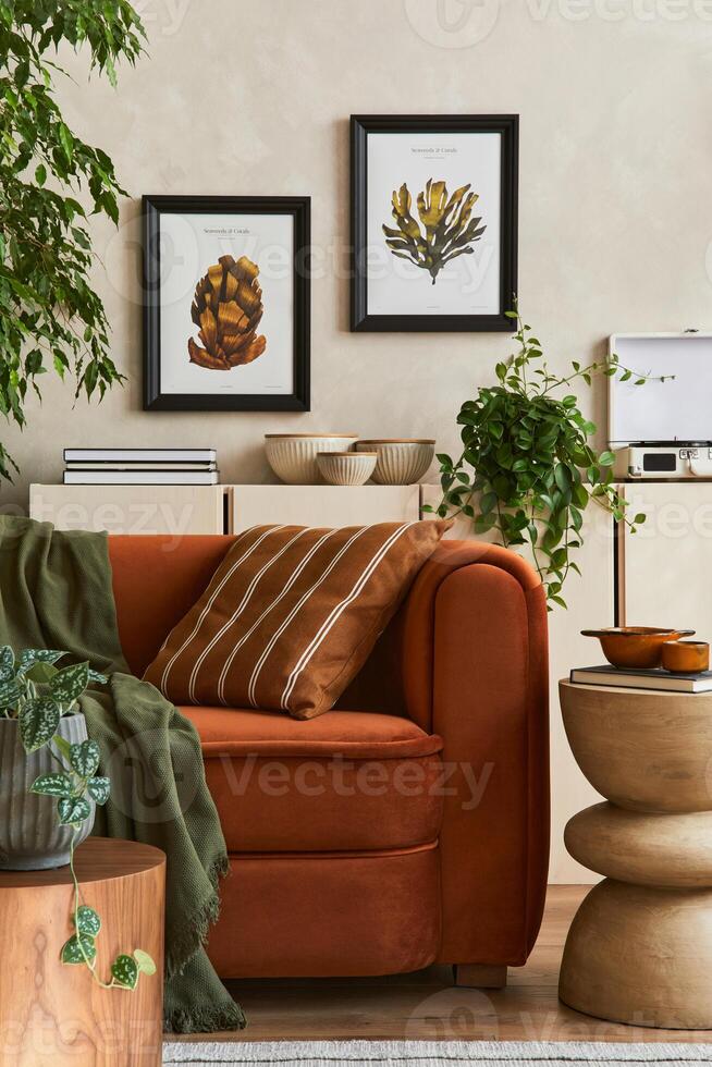 Creative interior composition of living room with designed couch, mock up poster frames, coffee table, palnts, books and personal accessoriers. photo