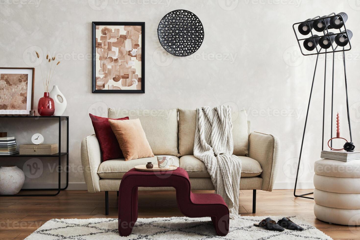 Elegant living room interior composition with beige sofa, black console, coffee table, pouf, mock up poster frame and creative design personal accessories. Template. photo