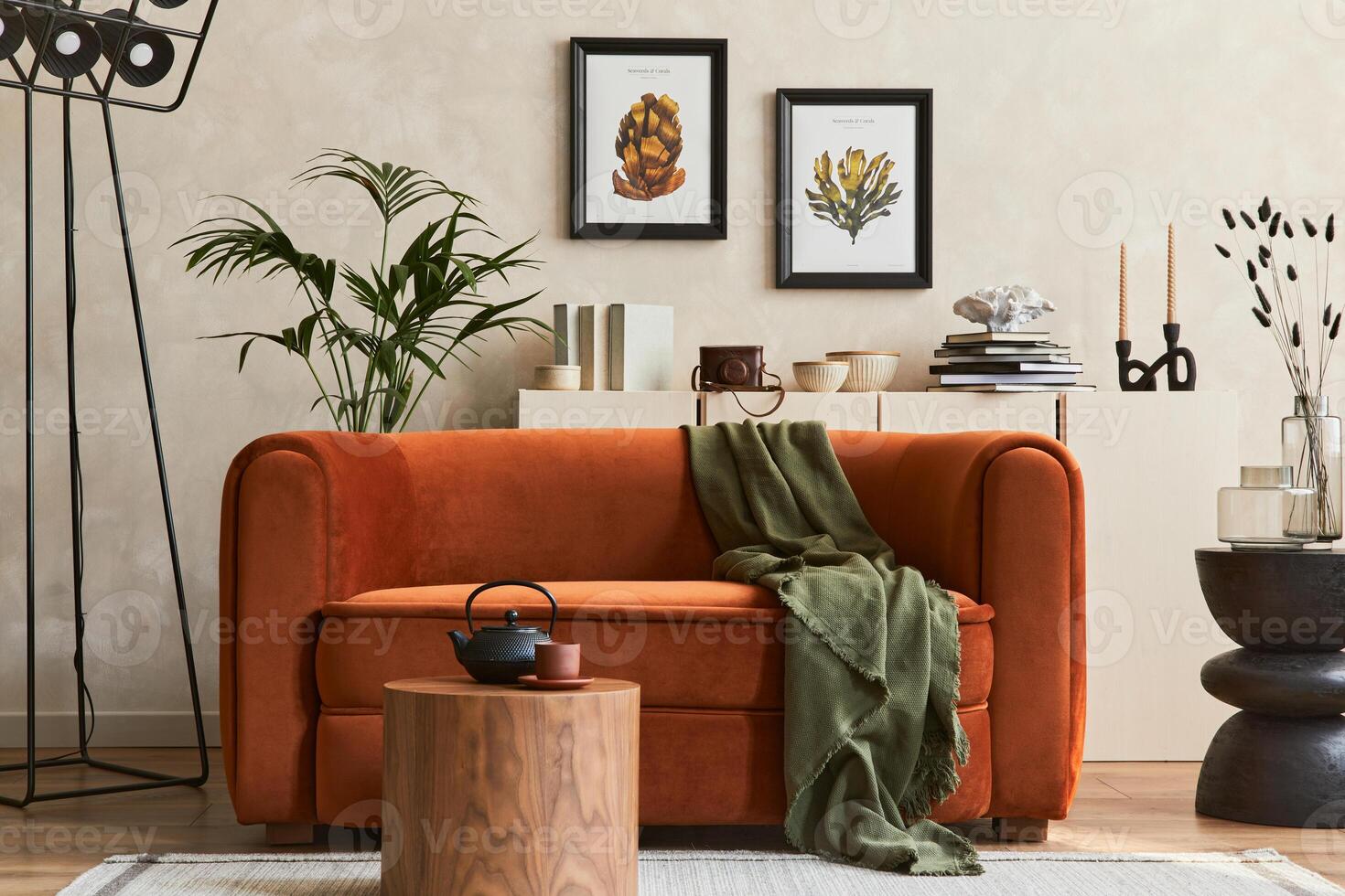 Stylish interior of modern living room with two mock up poster frames, retro design sofa, plants, coffe tables and creative personal accessories. Hipster space. photo