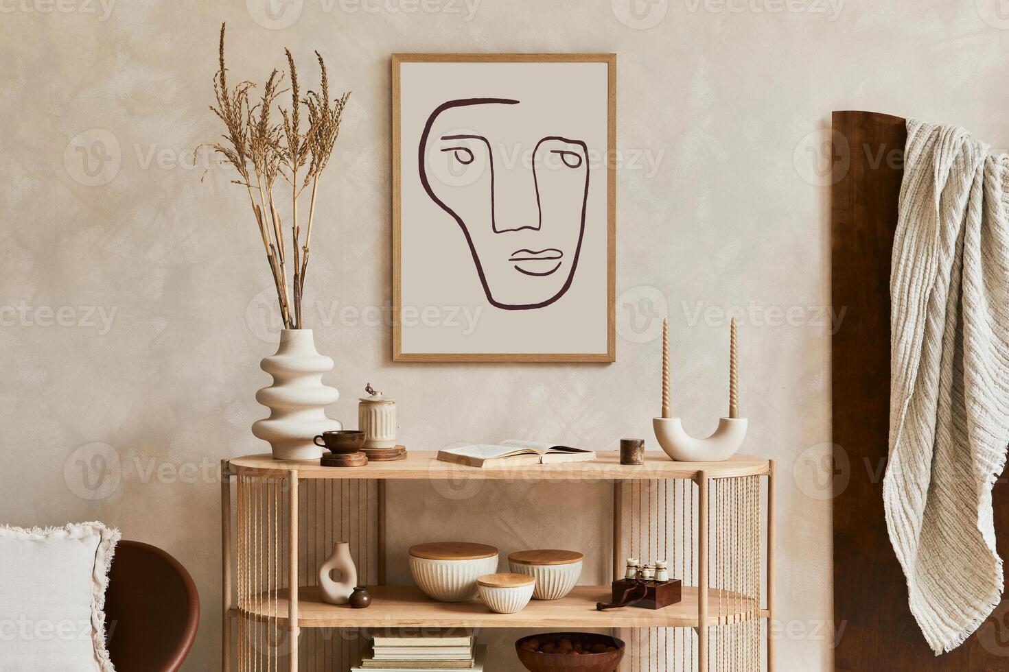 Creative interior composition with design wooden console, armchair and stylish personal accessories such as candlestick, vase and books. Template. photo