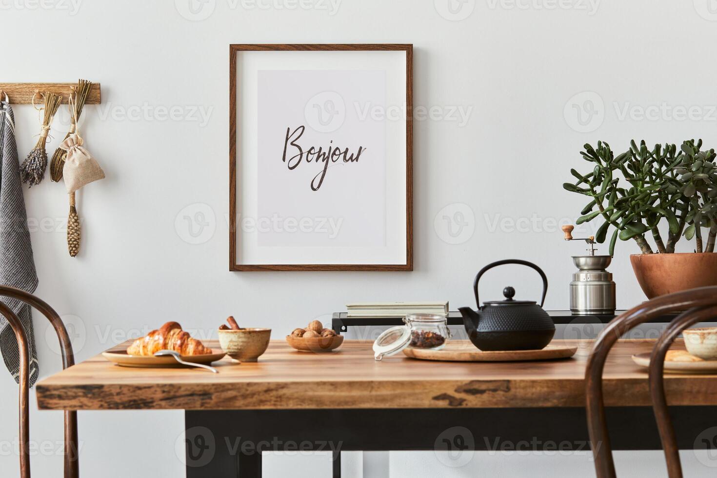 Stylish composition of cozy dining room intrerior with mock up poster frame, wooden family dining table, plants and vintage personal accessories. Copy space. Template. Autumn vibes. photo