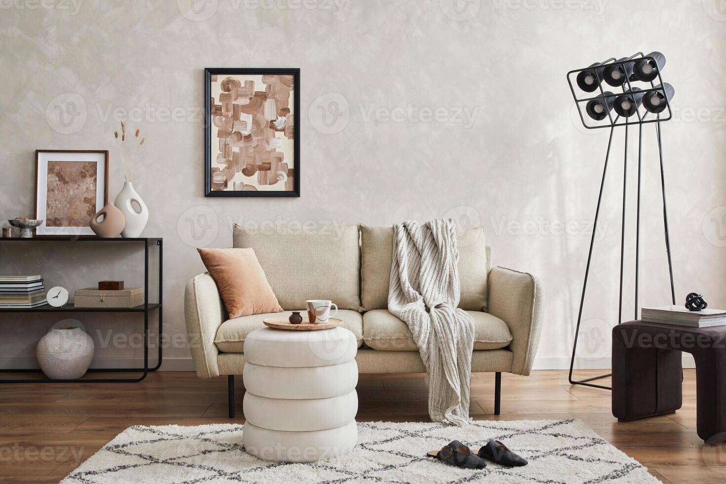 Elegant living room interior composition with beige sofa, black console, coffee table, pouf, mock up poster frame and creative design personal accessories. Copy space. photo