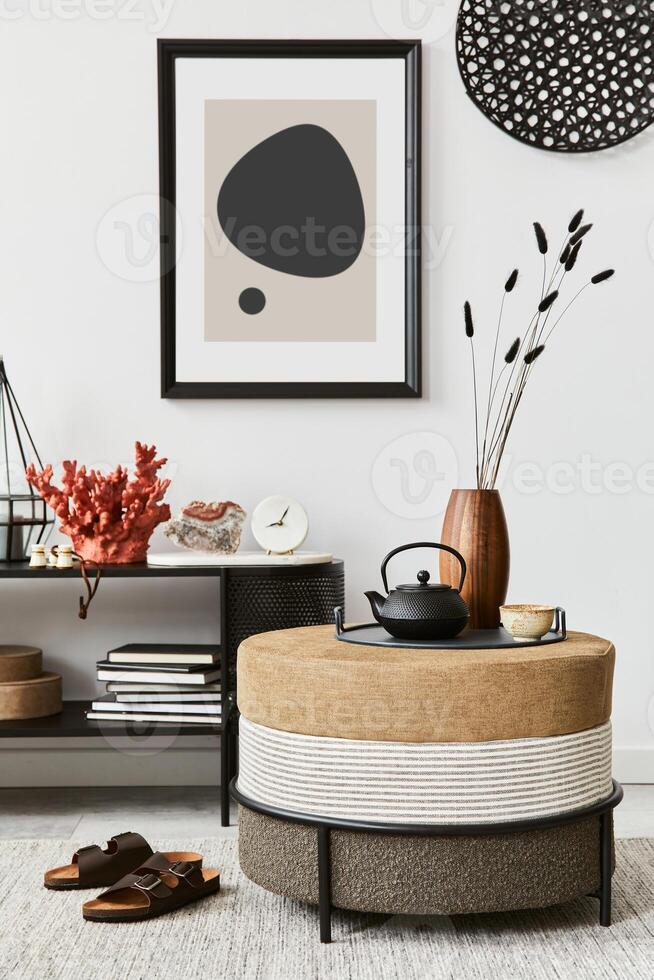 Stylish living room interior composition with mock up poster frame, pouf, console and elegant personal accessories. Copy sapce photo