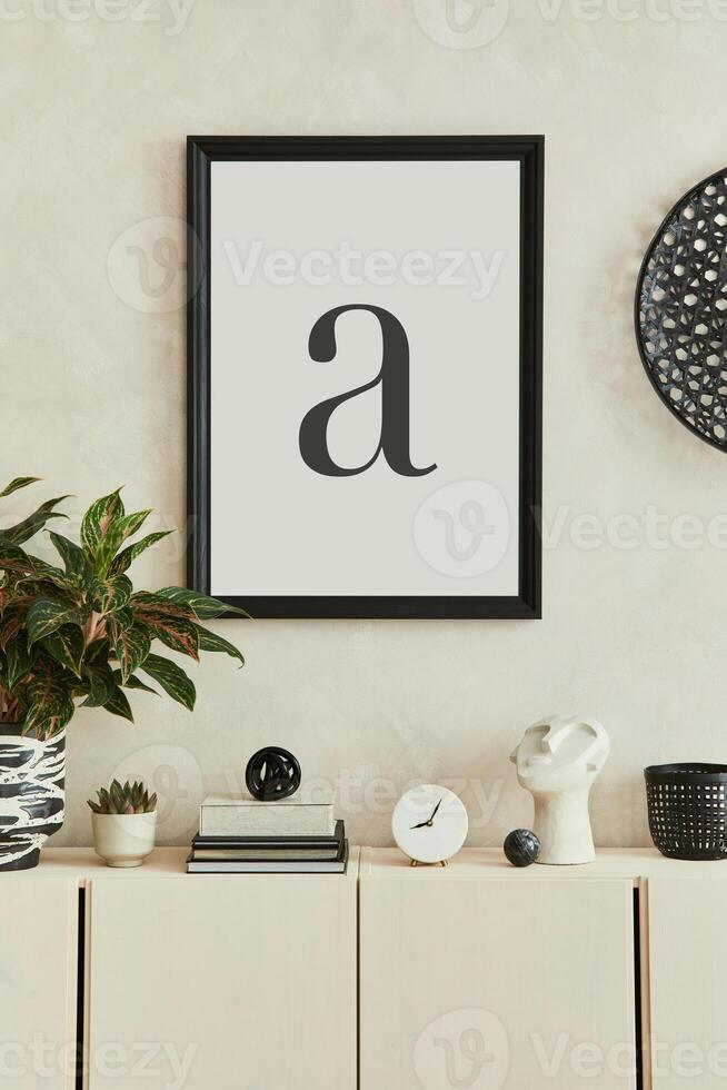 Creative composition of stylish living room intrerior with mock up poster frame, beige sideboard and minimalistic personal accessories. Copy space. Template. photo