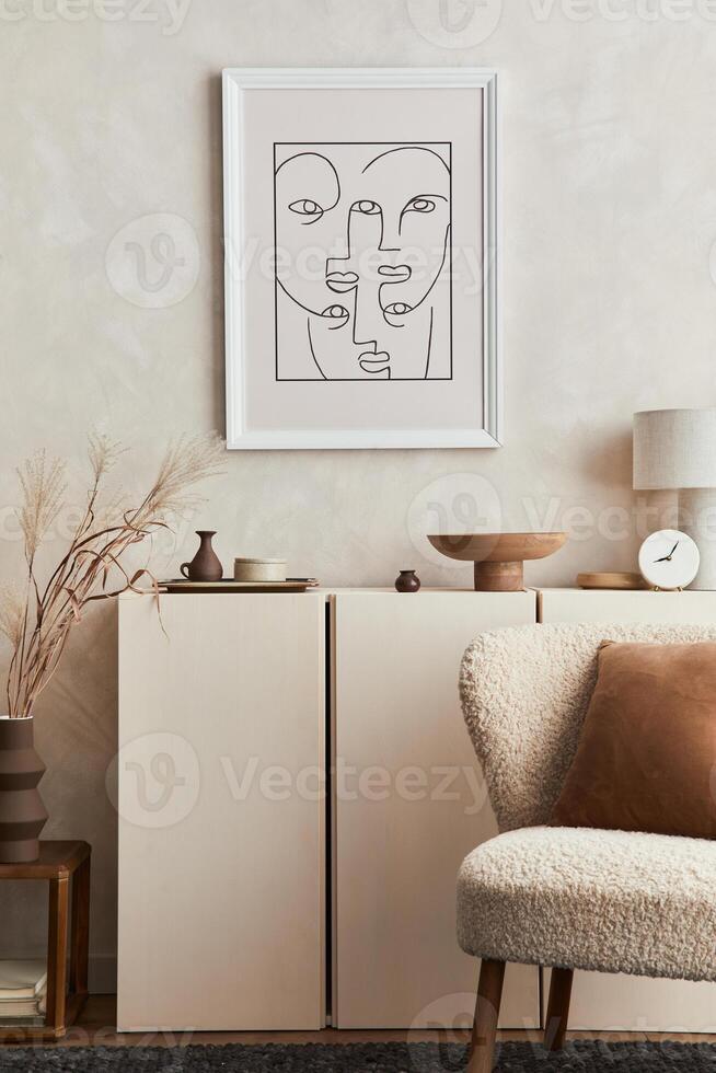 Stylish composition of creative interior design of living room with mock up poster frame, fluffy armchair, commode and personal accessories. Modern style. Template. photo