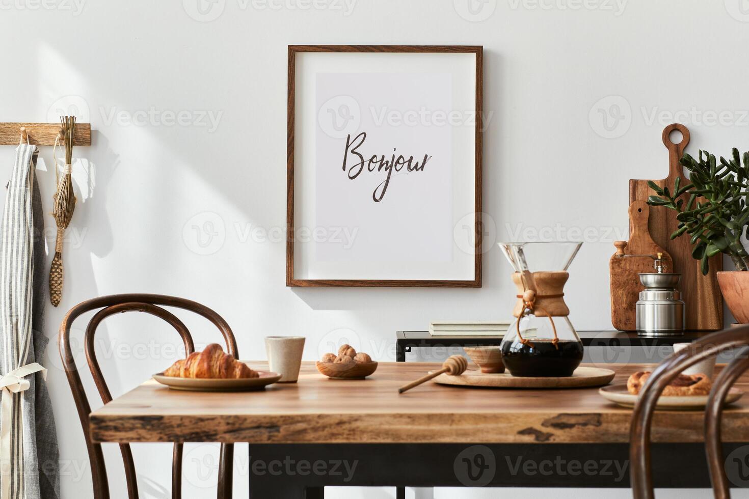 Stylish composition of cozy dining room intrerior with mock up poster frame, wooden family dining table, plants and vintage personal accessories. Copy space.. Autumn vibes photo