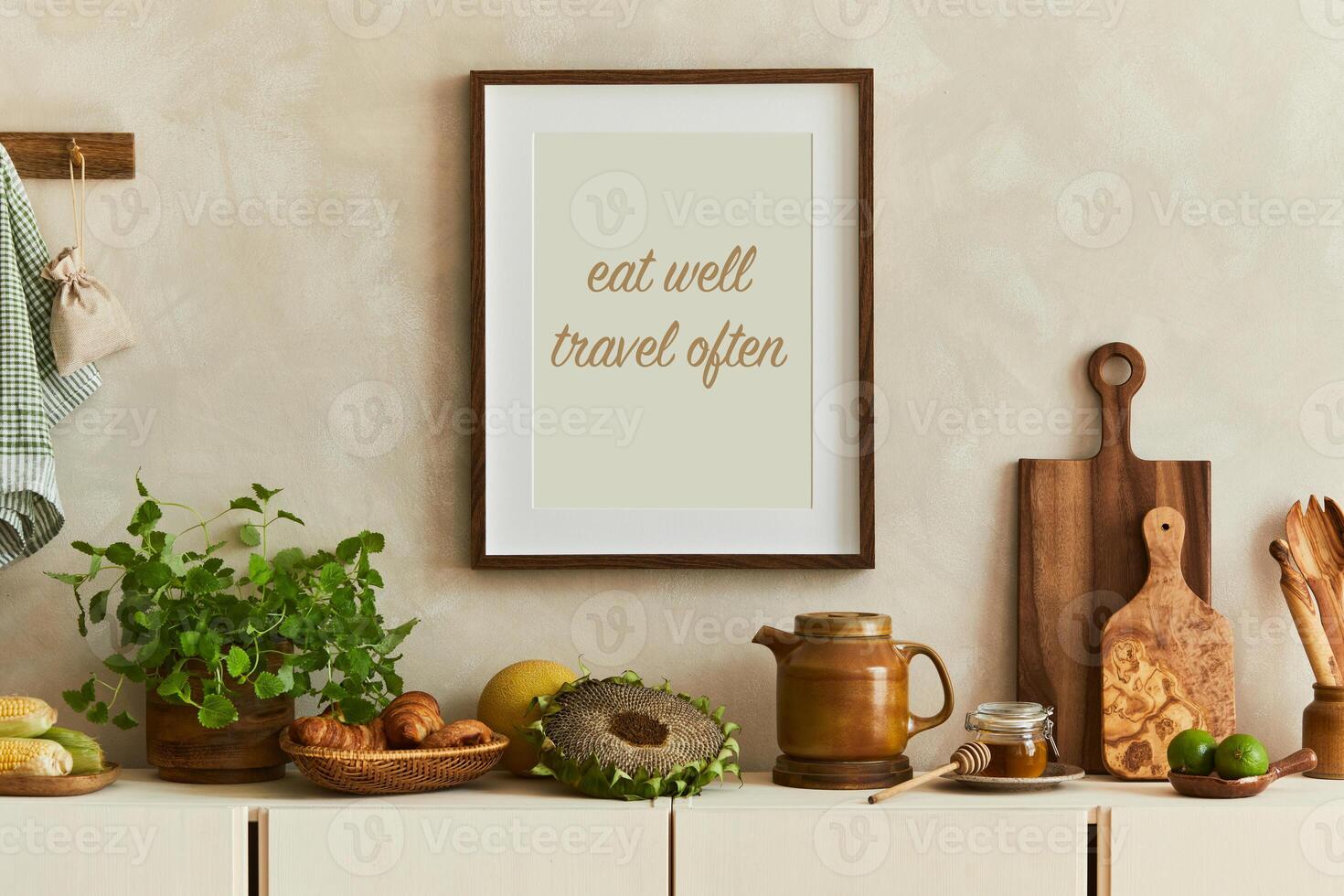 Stylish and modern kitchen interior composition with mock up poster frames, beige wooden sideboard, plants and retro inspired accessories. Autumn vibes photo
