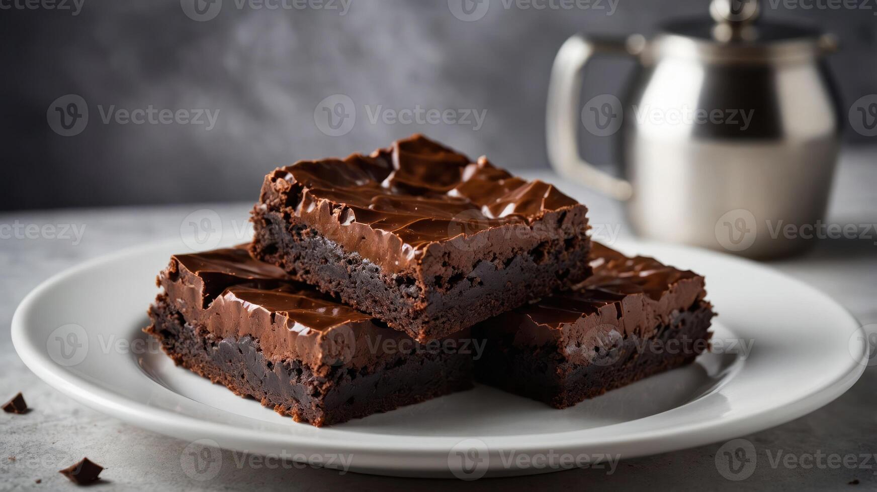 A plate of rich chocolate brownies, showcasing a glossy frosting and a tempting texture. photo