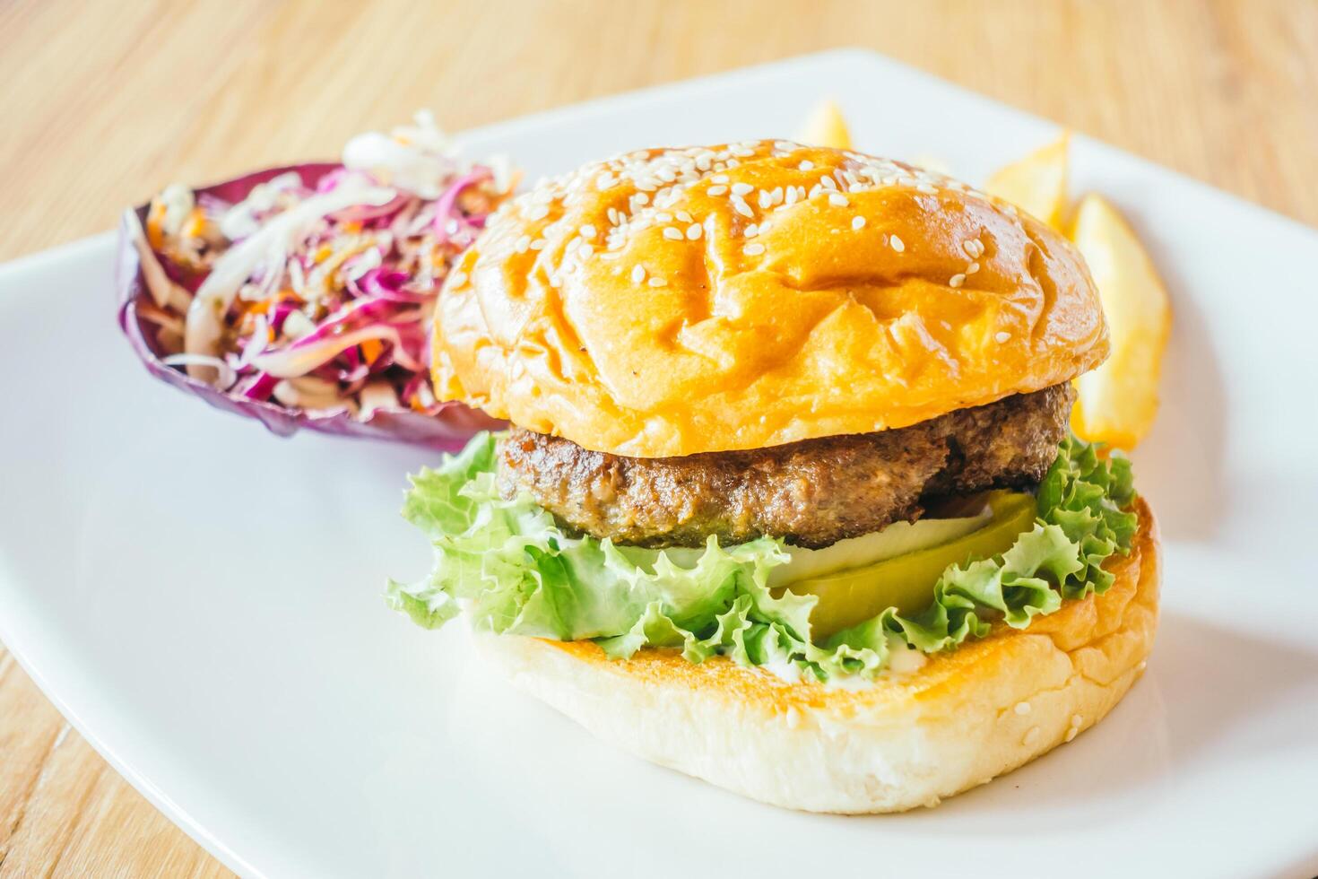 A hamburger and french fries on a plate photo
