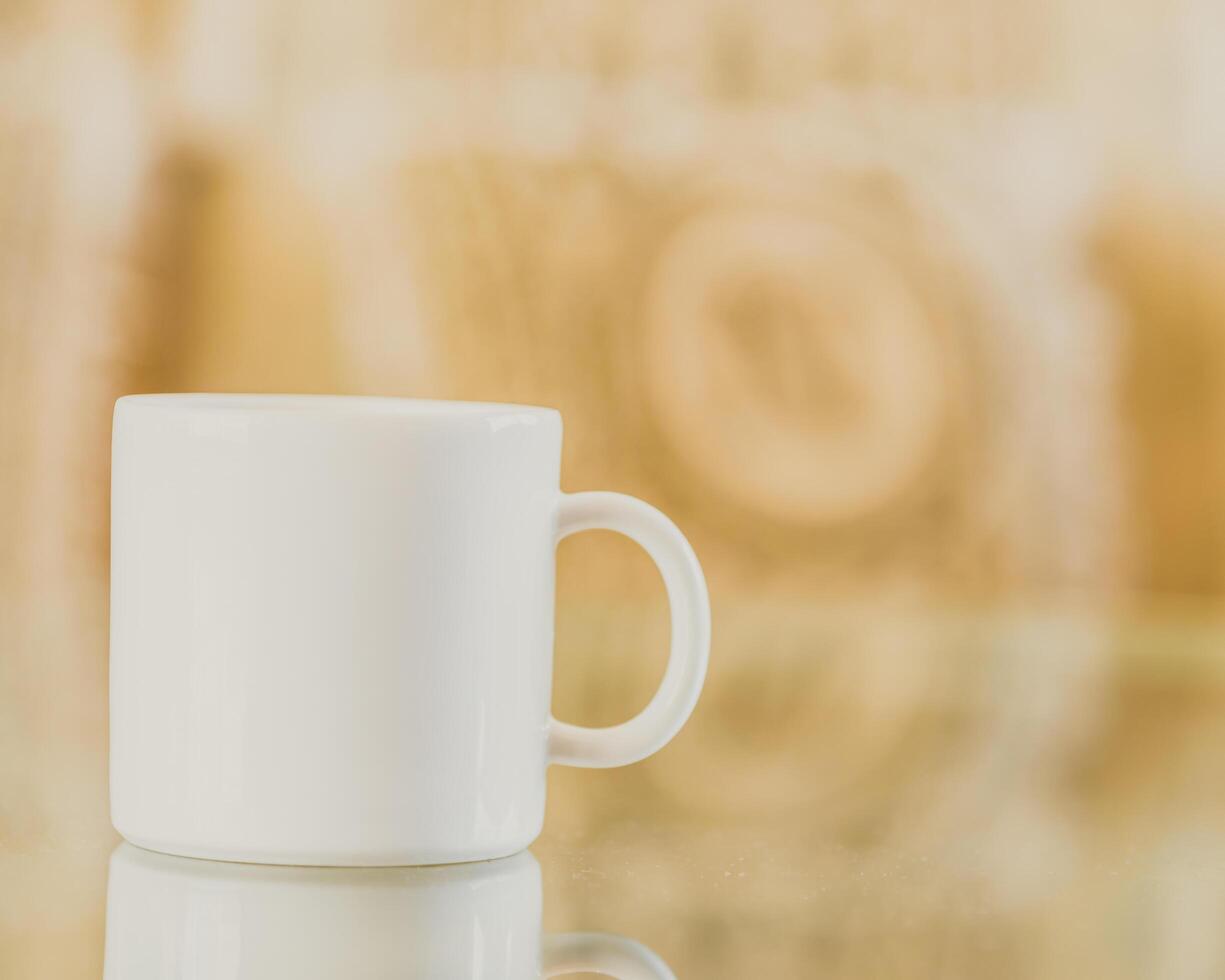 A white coffee cup sitting on a table photo