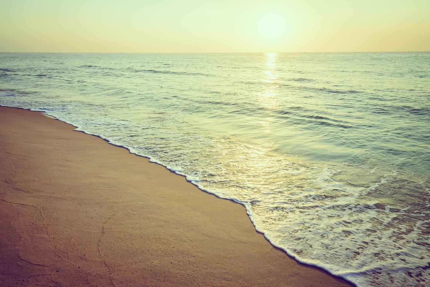 A beach with waves and sand photo