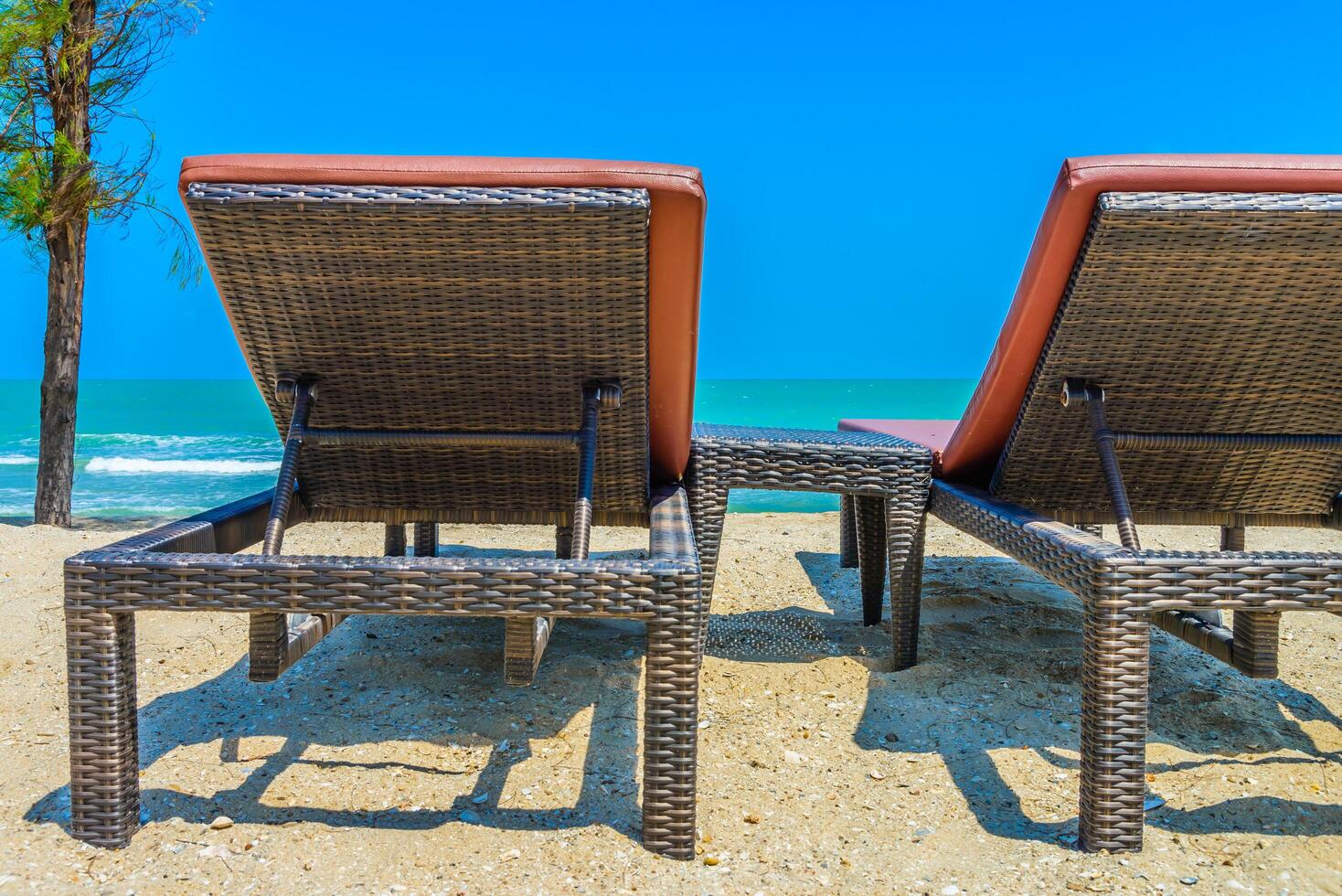 Two lounge chairs on the beach photo
