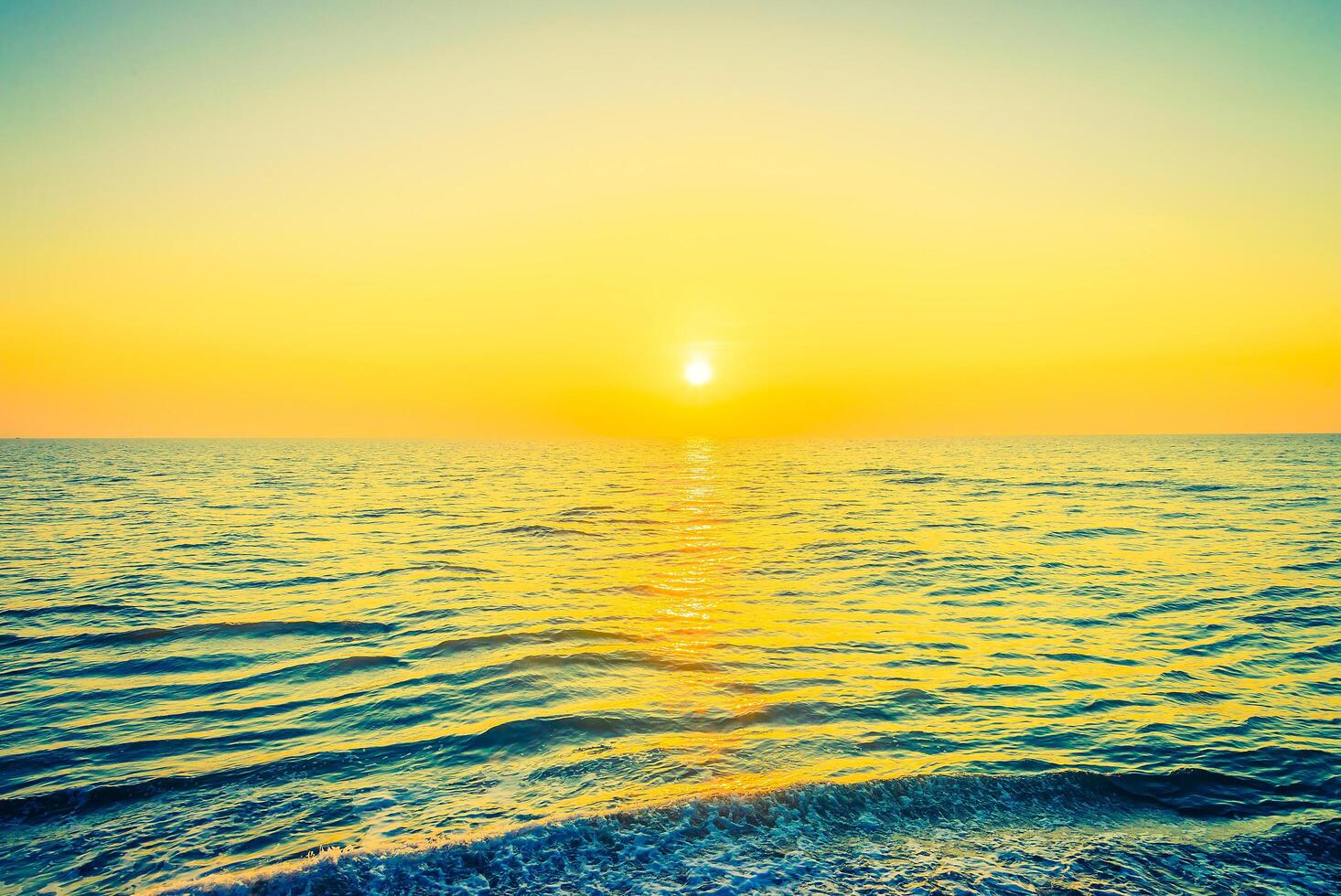 The sun is setting over the ocean photo