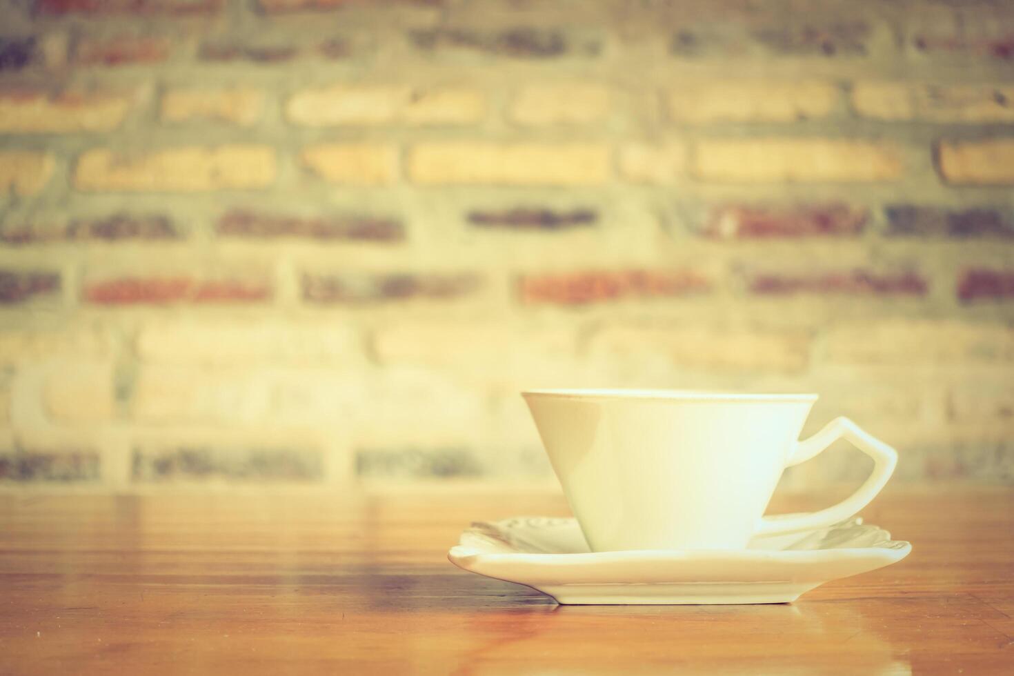 A white cup sitting on a saucer on a table photo