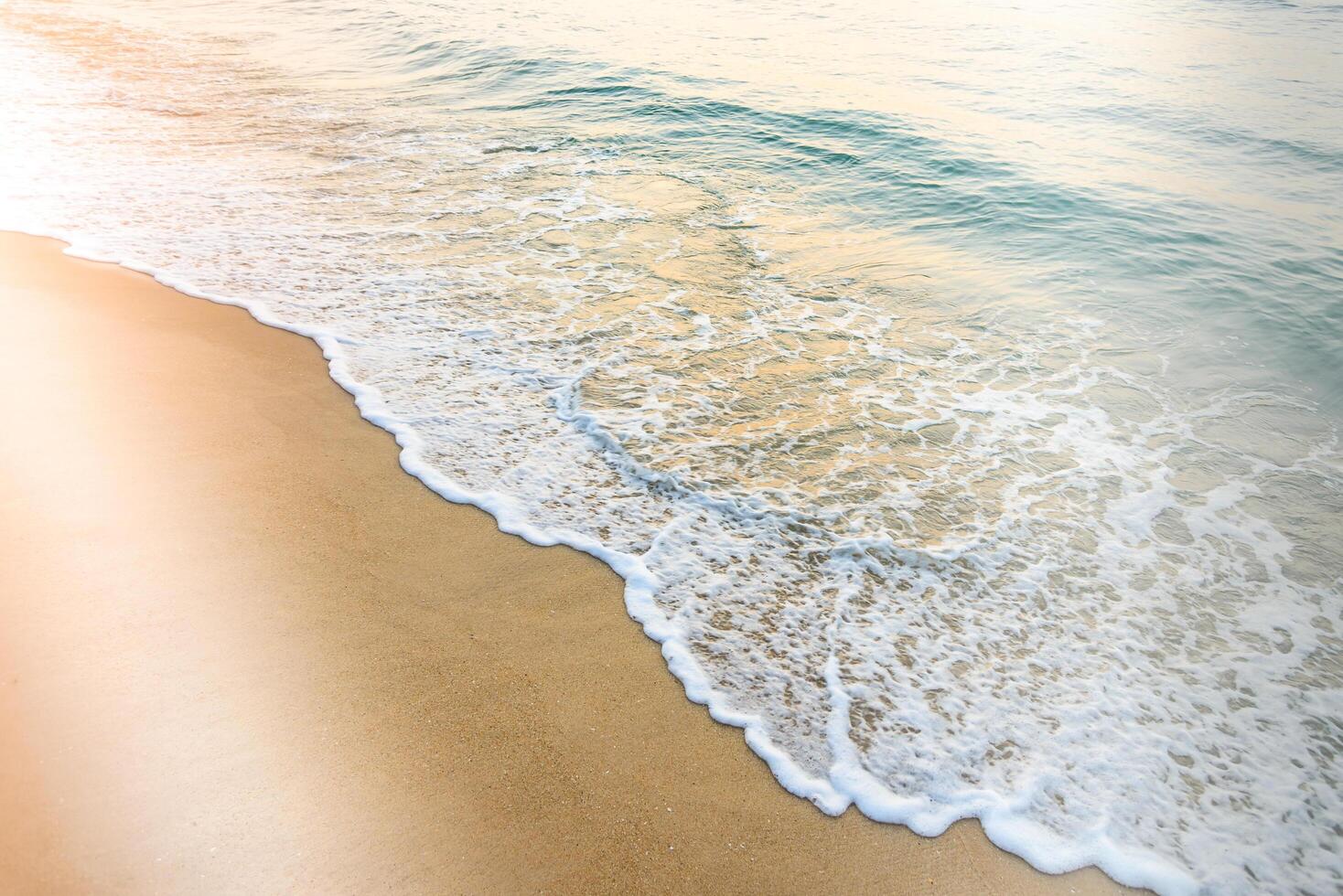 A beach with a wave coming in photo