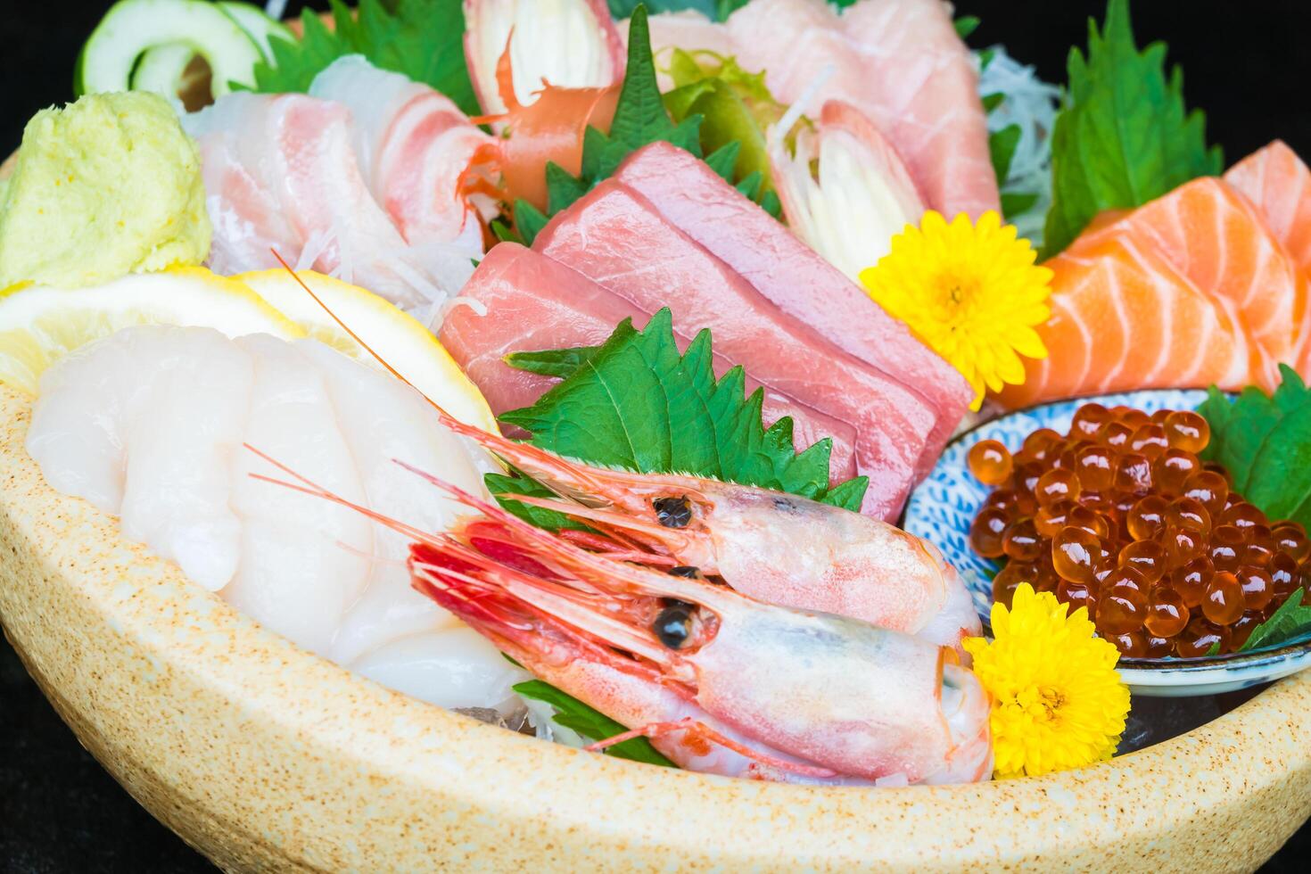 A bowl of sushi with various types of seafood photo