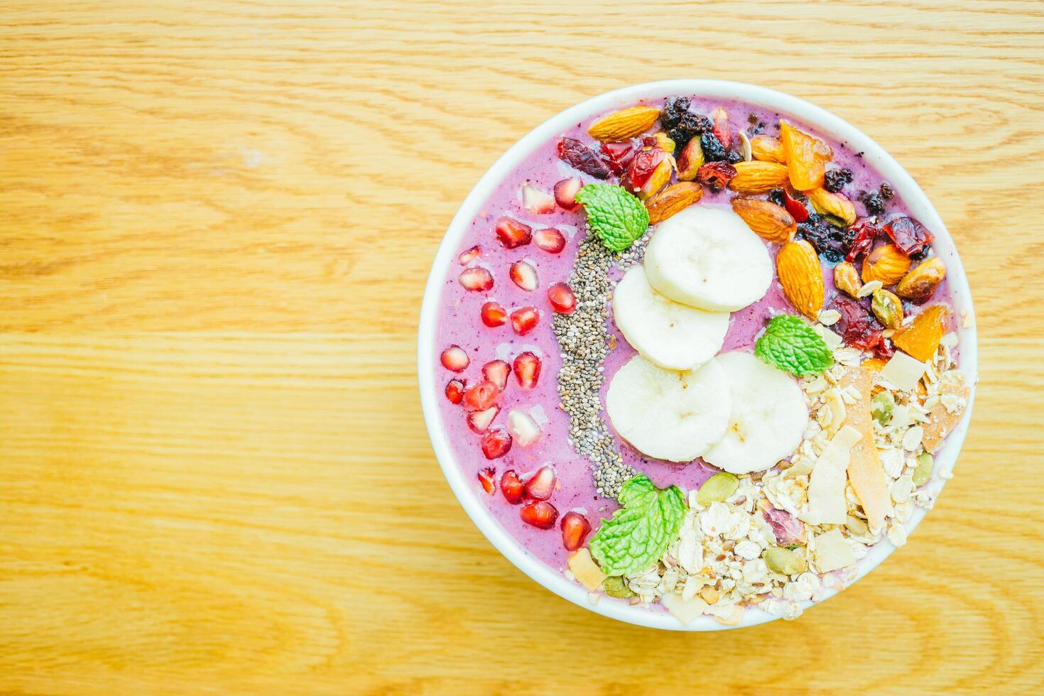 A bowl of fruit and nuts on a table photo